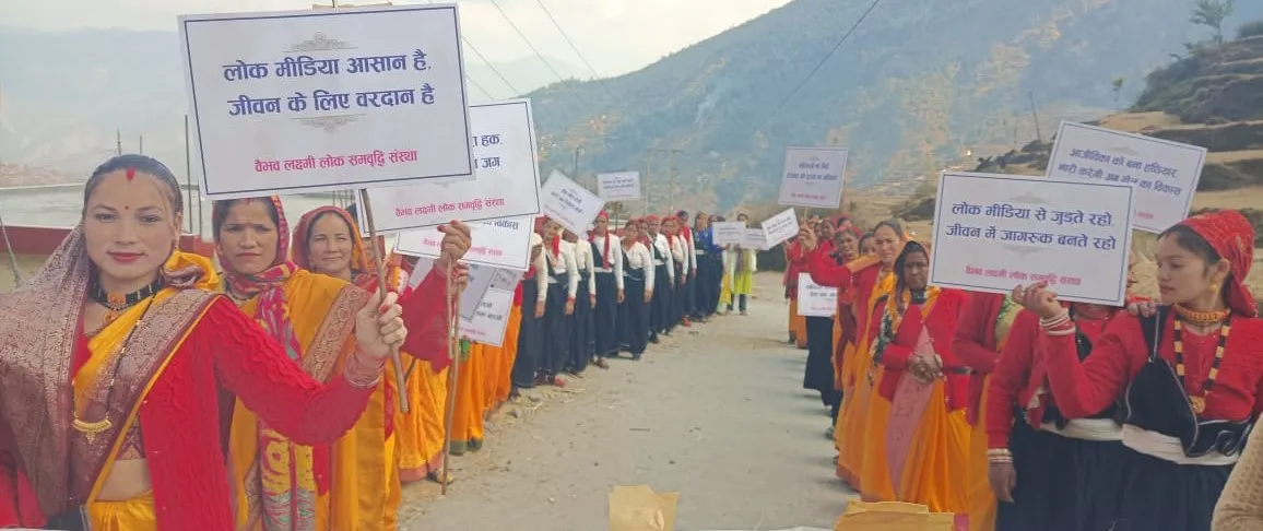 Women carrying awareness placards through a Himalayan village