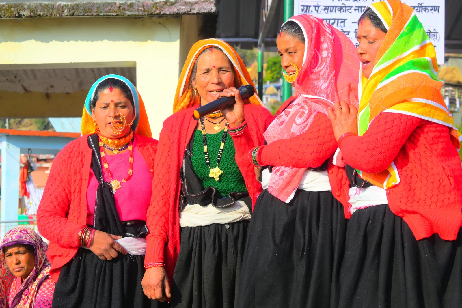 Women sharing traditional songs at a community event in Uttarakhand
